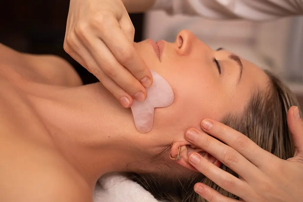 Gua Sha facial massage in Silom Bangkok spa – stone sculpting and lymphatic massage