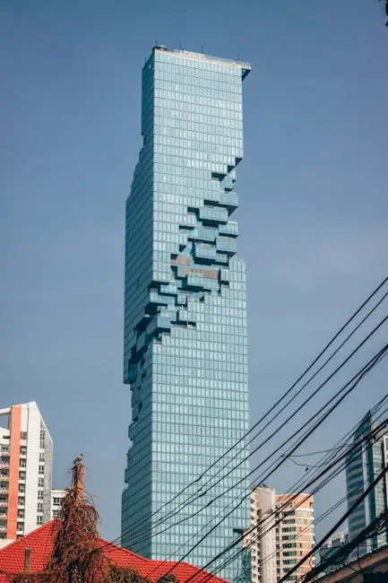 MahaNakhon Tower stands tall against a clear blue sky in Bangkok, Thailand.