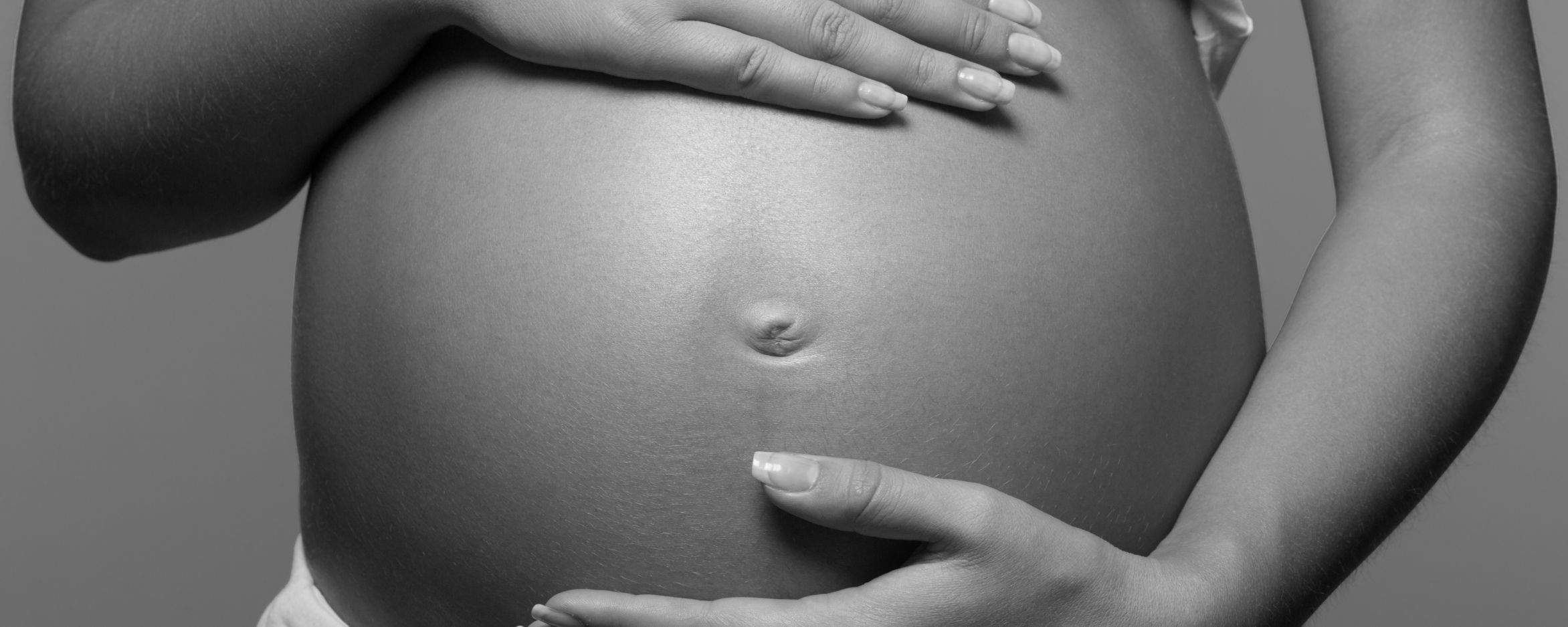 Pregnant woman sitting black and white photo